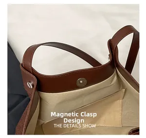 Gros plan du fermoir magnétique sécurisé et de la doublure beige du sac cabas marron