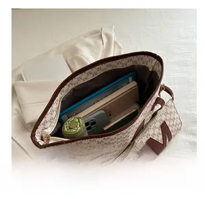 Large capacity tote bag showing spacious interior with tablet, books and umbrella