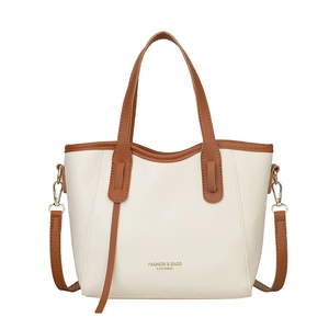 Minimalist cream and dark brown contrast faux leather tote bag with adjustable shoulder strap