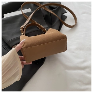 Detail showing high-quality texture contrast of suede and smooth leather on brown tote bag