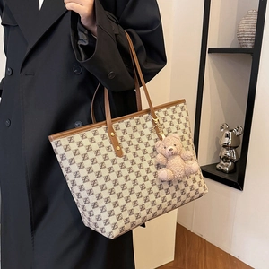 Classic canvas tote bag with brown leather trim and cute teddy bear charm