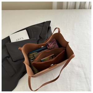 Spacious brown tote bag interior with magnetic closure and matching zipper pouch
