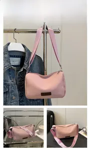 Detail of pink fashion shoulder bag with adjustable strap and zip closure