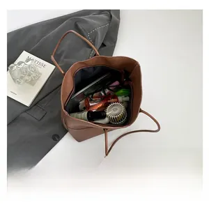Internal view of a brown pebbled leather tote bag showing large capacity for essentials
