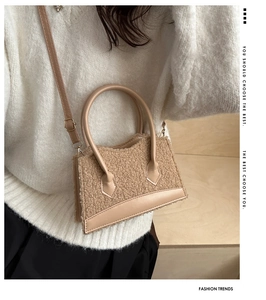 Fashionable beige plush handbag with leather trim shown on a model for autumn style