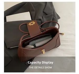 Detail view of the spacious inner compartment and zipper pocket of this brown crossbody bag