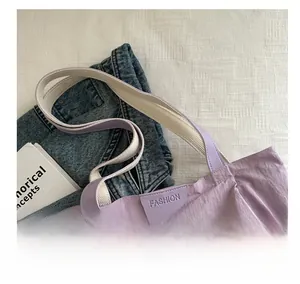 Detail of lavender nylon tote bag with fashion leather patch and bicolor handles