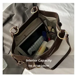 Detailed internal capacity of a brown tote bag showing iPad, cosmetics, and phone