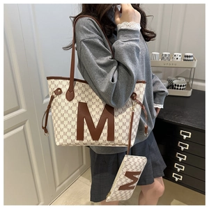 Detail of the large tote and clutch set with letter print and brown leather trim