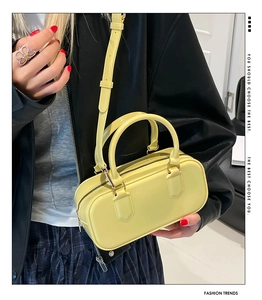 Fashionable bright yellow PVC jelly pillow bag worn by a model in a trendy outfit