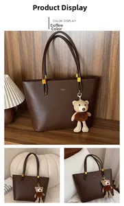 Detailed shot of coffee brown tote bag with premium leather texture and a bear charm