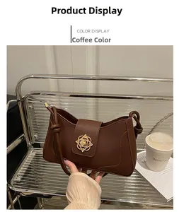 Detail of coffee brown PU shoulder bag featuring a gold floral cutout metal clasp