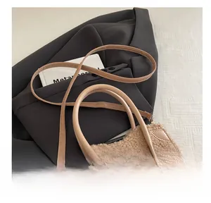Detail of adjustable leather strap and faux fur texture on a chic crossbody handbag