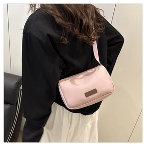 Vue de dos d'un mannequin portant le sac à bandoulière rose avec sangle large