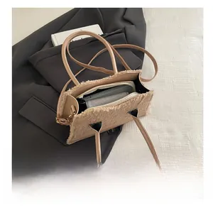 Detail view of the spacious plush tote bag interior with a smartphone and wallet