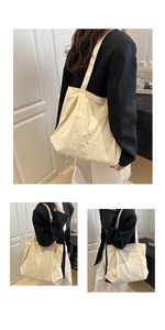 Detail of minimalist cream tote bag showing the side fashion logo and light nylon texture