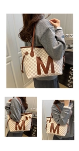 Macro detail of high-capacity tote bag with brown M-pattern and sleek faux leather straps