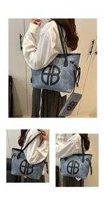 Detail of light blue denim tote bag with circular logo and matching small coin purse