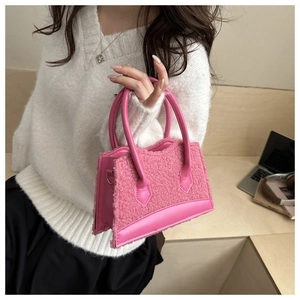 Pink plush faux fur handbag with leather trim shown in a stylish lifestyle setting