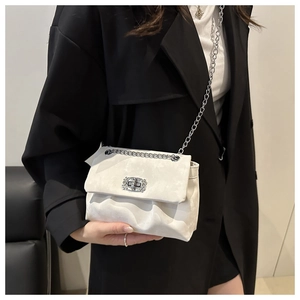 Detail of off-white chain bag featuring textured soft leather and a diamond-encrusted clasp