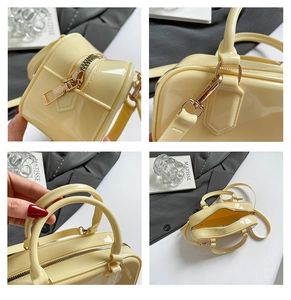 Macro detail of glossy jelly pillow bag featuring golden zipper and metal hardware hooks