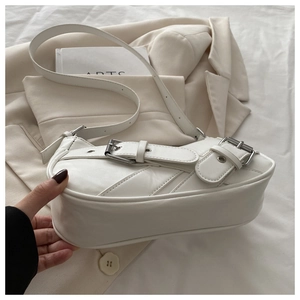 Close-up of white PU leather hobo bag with vintage silver metal buckles and adjustable strap