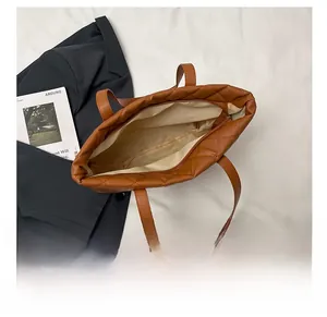 Top view of spacious brown quilted tote bag showing large interior storage and zipper
