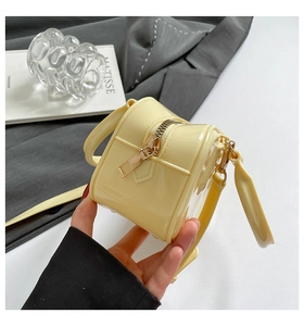 Macro detail of glossy lemon yellow mini tote bag with smooth zipper closure