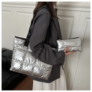 Detail of silver quilted tote bag and matching pouch set with black nylon straps