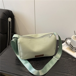 Stylish mint green crossbody bag in soft fabric with adjustable strap for daily fashion