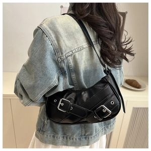 Detail of a black crescent PU leather shoulder bag with silver metal buckle rings