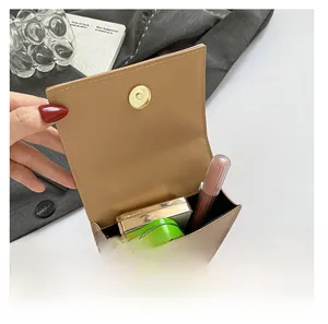 Internal view of brown crossbody bag showing space for lipstick and small items