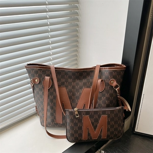 Brown tote bag and pouch set with monogram M pattern and large leather M patch