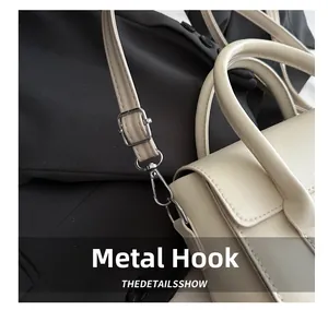 Detailed shot of silver-toned metal hardware hook and adjustable leather shoulder strap