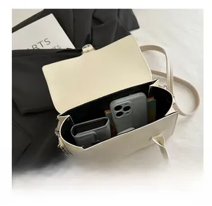 Interior view showing the storage capacity of this cream crossbody handbag for daily essentials
