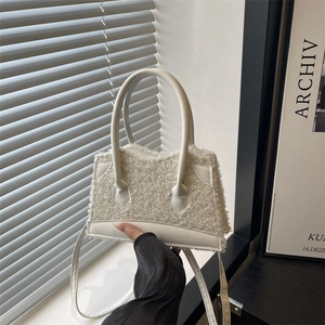 Chic white faux fur handbag for women with dual leather handles and a long shoulder strap