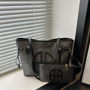 Minimalist dark gray tote bag set with embossed circular logo and matching small pouch