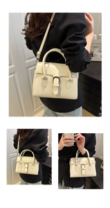 Detail view of the beige minimalist leather handbag with metal buckle and shoulder strap