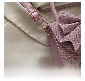 Macro detail of high-quality gold metal hardware and pink sequin fabric on evening bag