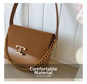 Detail showing caramel leather and suede patchwork with gold chain and metal T-clasp
