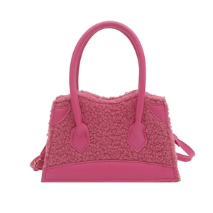 Pink faux shearling crossbody handbag with leather handles and adjustable strap for women