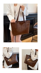 Detail of dark brown PU leather tote bag with baseball pendant and slim shoulder straps