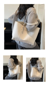 Detailed view of the minimalist ivory tote bag showing stitching and golden logo print