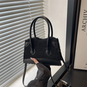 Black plush faux fur tote bag with leather trim and handle for autumn winter fashion