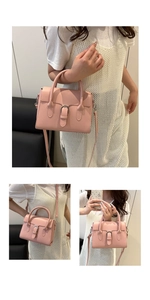 Detailed view of pink structured square crossbody bag with handle and buckle strap