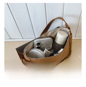 Top view showing internal capacity of the brown crossbody bag with daily essentials