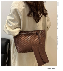 Detail of checkered tote bag with gold chain strap and matching detachable pouch