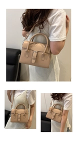 Detail view of beige retro crossbody bag with silver buckle and adjustable strap