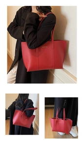 Close-up of red lychee pattern tote bag with gold FASHION & BAGS lettering detail