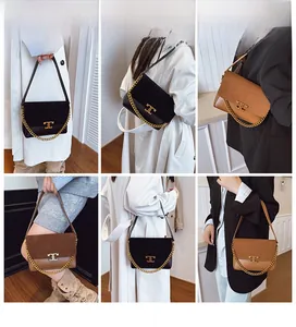 Detail view of stylish crossbody bag with interlocking gold metal clasp and chain strap